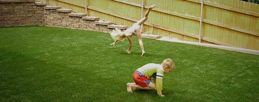 Children Playing in their backyard on ForeverLawn artificial grass.